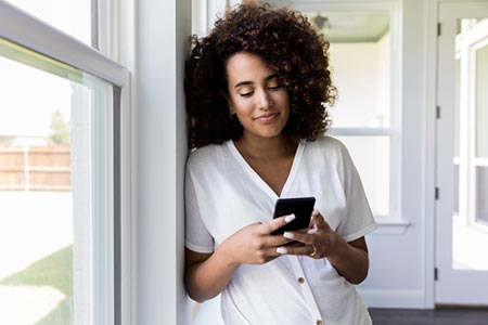 woman texting thank you to Bi-Racial Adoptions via text on her phone
