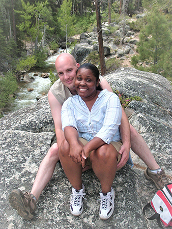 Sitting together on a rock during a hike, Zachary and Angela, a hopeful Bi-Racial adoptive family
